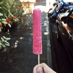 Close-up of hand holding flavored ice