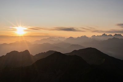 Scenic view of silhouette mountains against sky during sunset