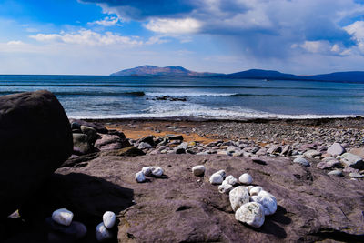 Rocks on beach against sky