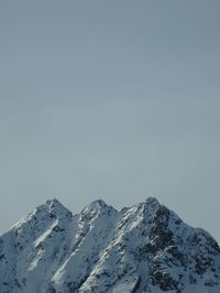 Scenic view of snowcapped mountains against clear sky