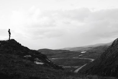 Man standing on mountain against sky