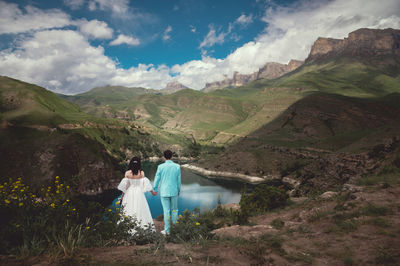 Rear view of woman walking on mountain