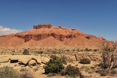 Scenic view of desert against blue sky