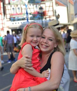 Portrait of mother and daughter in amusement park