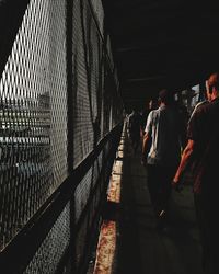 Rear view of people walking on floor in city