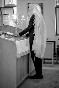 Jewish man praying in the synagogue tample of israel practicing the reading of the torah.