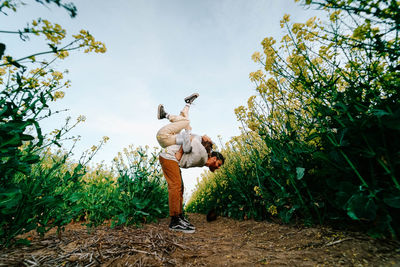 Full length of man standing on field against sky