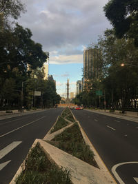 Road by city against sky