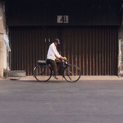 Man with bicycle on road