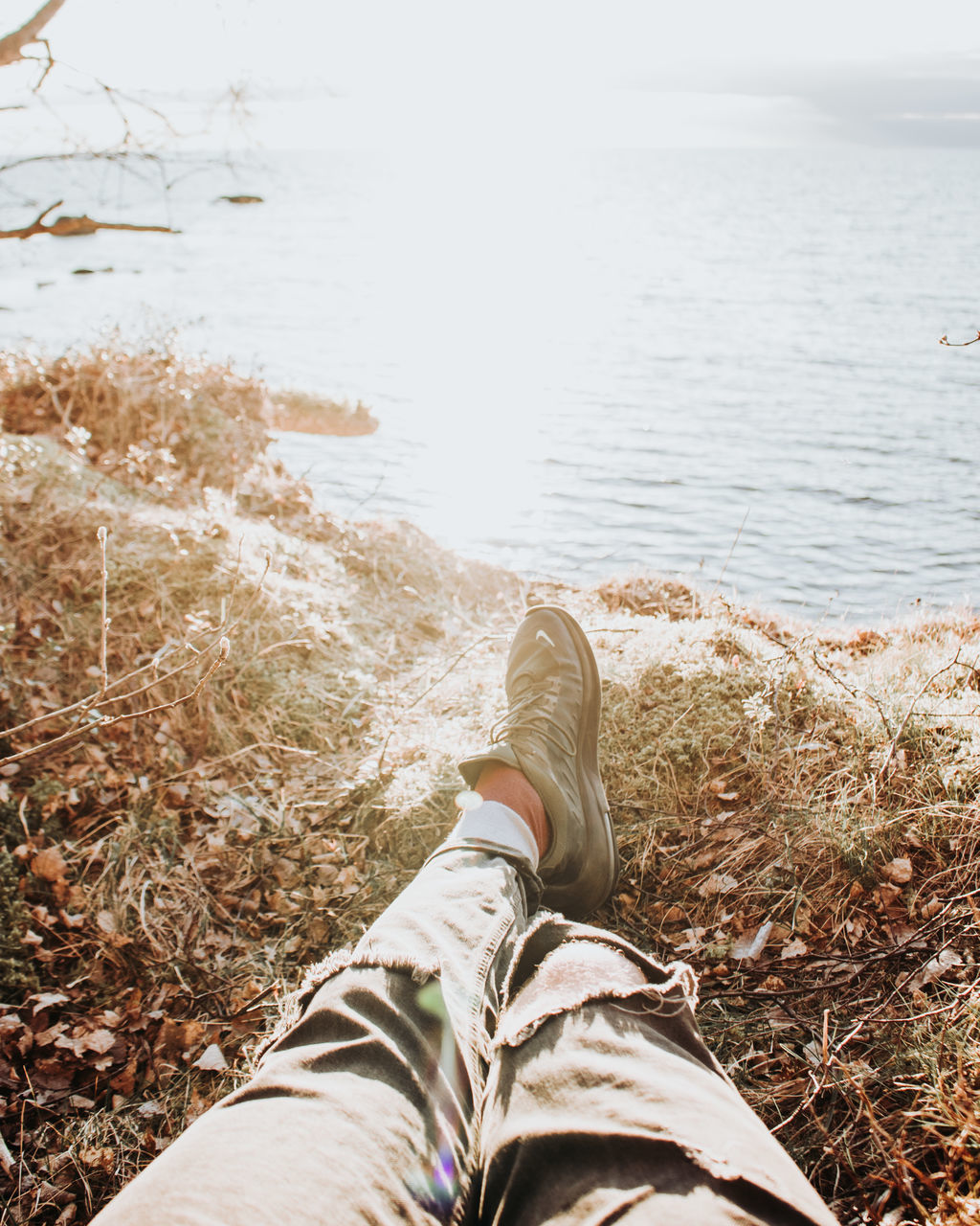 LOW SECTION OF PERSON RELAXING ON LAND