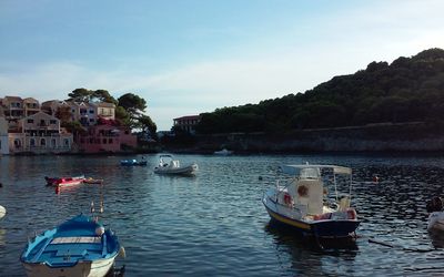 Boats in river with buildings in background
