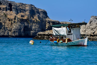 Boat in sea against blue sky