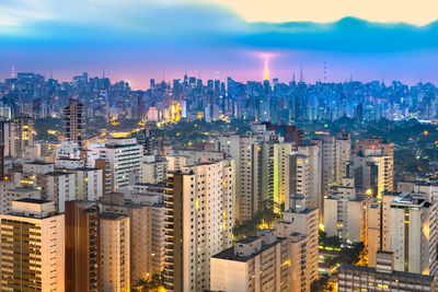 High angle view of modern buildings in city against sky