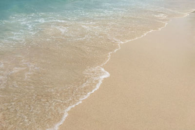 High angle view of waves rushing towards shore