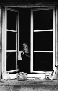 Man standing by window in house