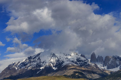 Low angle view of snow mountains against sky