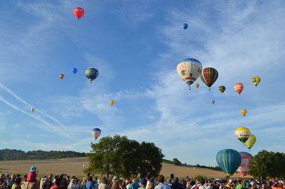 Low angle view of hot air balloons flying in sky