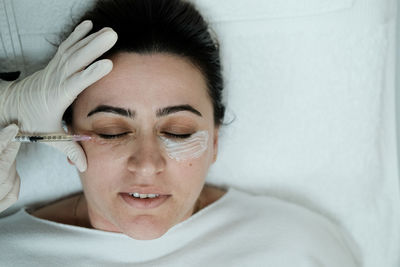 Top view of female patient having eye mesotheraphy applied