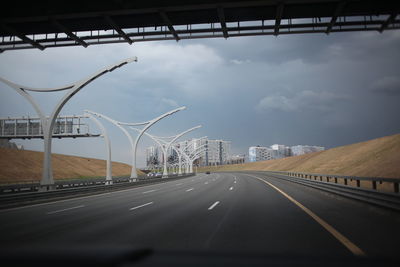 Road against sky seen through car windshield