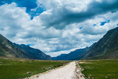 Scenic view of lake and mountains against dramatic sky