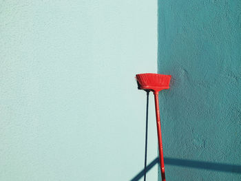 Close-up of red bell against wall