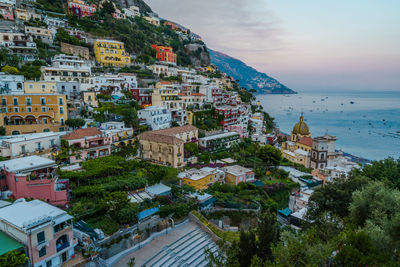 High angle view of townscape by sea against sky