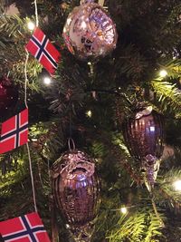 Christmas decorations hanging on christmas tree