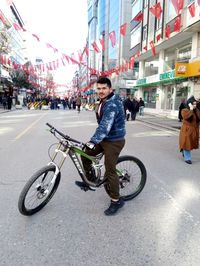 Man riding bicycle on city street