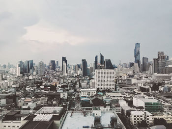 High angle view of modern buildings in city against sky