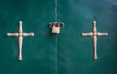 Close-up of cross on old wooden door