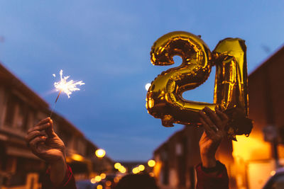 Man and woman couple holding gold foil balloons numeral 2021. new year celebration concept.