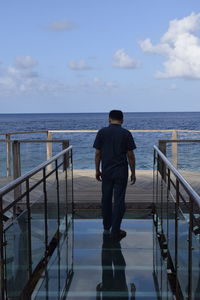 Rear view of woman standing in boat