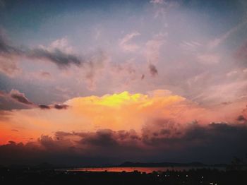 Silhouette landscape against dramatic sky during sunset