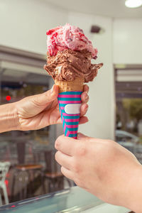 Close-up of hand holding ice cream cone