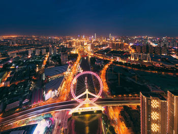 Illuminated modern buildings in city at night