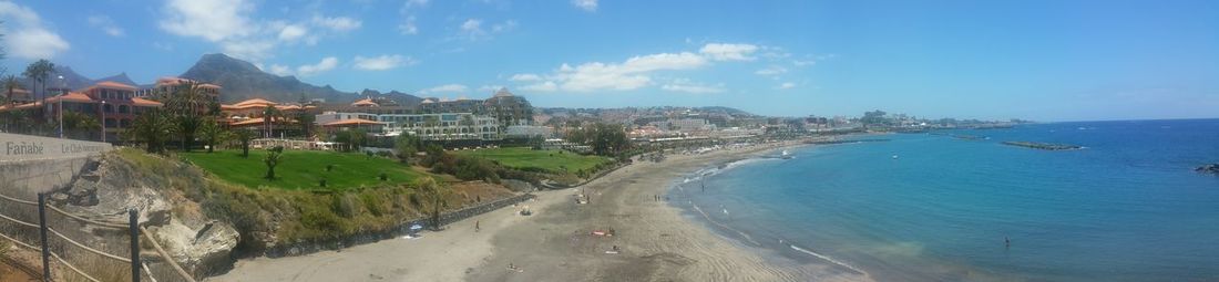 Panoramic view of sea and city against sky