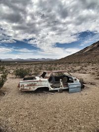 Abandoned built structure on landscape against sky