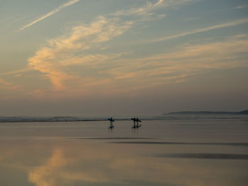 Sunset surfers on westward ho beach in north devon 