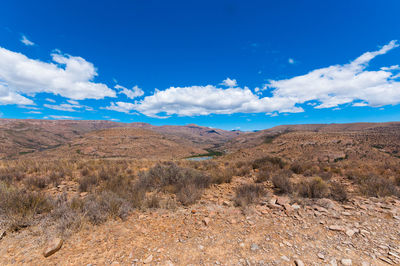 Scenic view of desert against blue sky