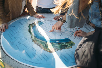 Friends pointing towards a map