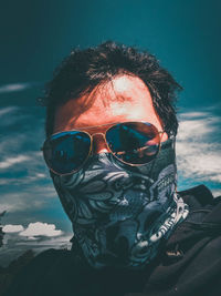 Portrait of man wearing sunglasses against sky