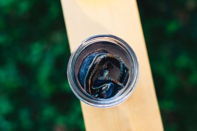 Close-up of fabric in jar on railing