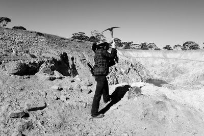 Full length of man working on landscape