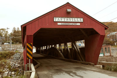 Information sign on bridge against sky