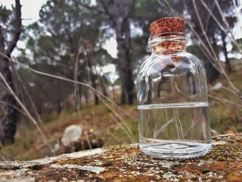 Close-up of glass bottle on table