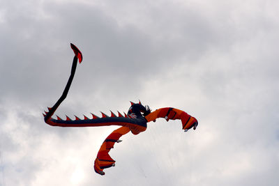 Low angle view of paragliding against sky