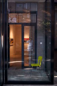 Reflection of man on glass window of building