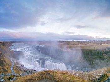 Scenic view of waterfall against sky in iceland, gulfoss 