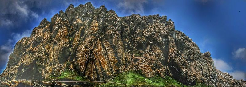 Low angle view of rocks against sky