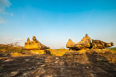 Rock formations on landscape against sky